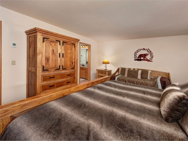 bedroom featuring ensuite bathroom and carpet flooring