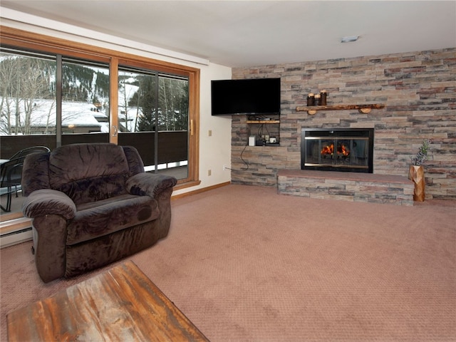 carpeted living area featuring baseboard heating, baseboards, and a stone fireplace