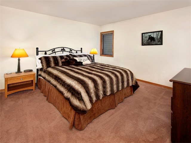 bedroom with light carpet and baseboards