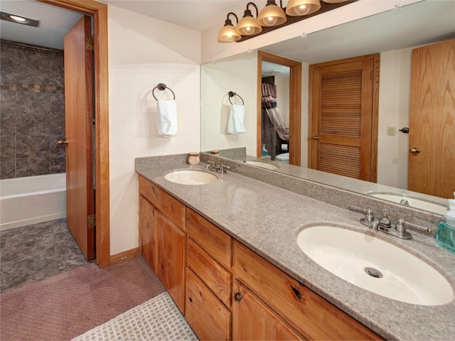 bathroom with toilet, a sink, and double vanity