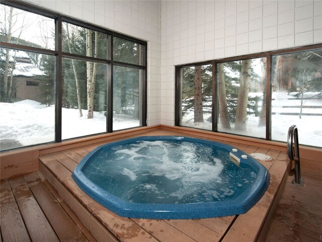 22804 US Highway 6 Unit 102, Keystone, CO 80435 - sunroom featuring a jacuzzi and plenty of natural light