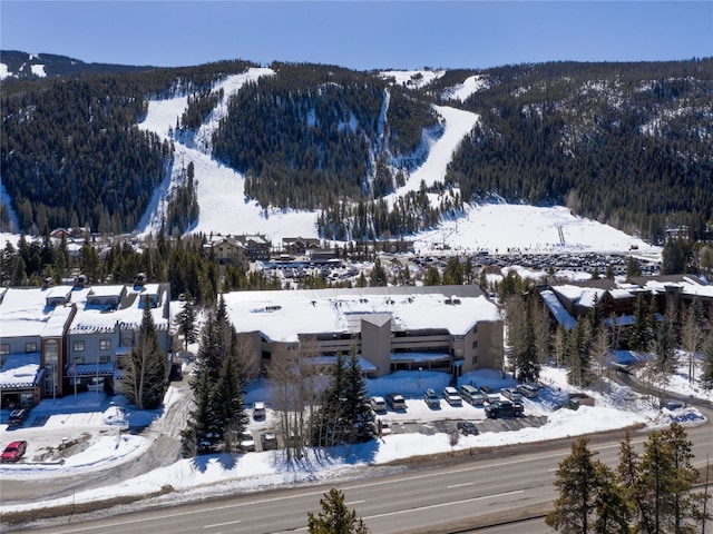 snowy aerial view with a mountain view