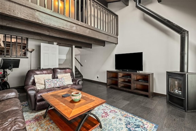 2583 Apres Ski Way Unit 4, Steamboat Springs, CO 80487 - living area with stairway, dark wood-style floors, baseboards, a wood stove, and a high ceiling
