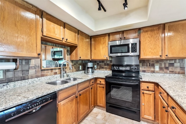 4612 Ryan Gulch Rd Unit 4612, Silverthorne, CO 80498 - kitchen with black appliances, decorative backsplash, light stone countertops, and brown cabinetry