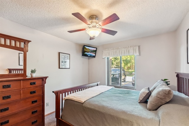 4612 Ryan Gulch Rd Unit 4612, Silverthorne, CO 80498 - bedroom with a textured ceiling, carpet floors, ceiling fan, and access to outside