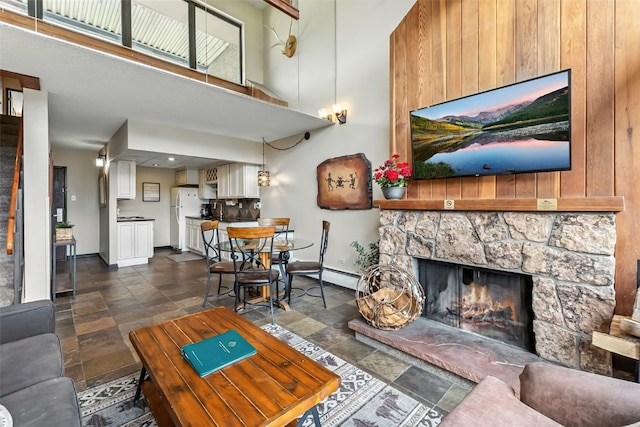 631 Village Rd Unit 34330, Breckenridge, CO 80424 - living area with stone finish flooring, a fireplace, and a towering ceiling