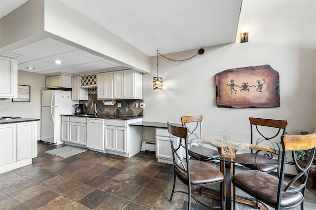 631 Village Rd Unit 34330, Breckenridge, CO 80424 - dining room with a baseboard heating unit, dark stone finish flooring, and recessed lighting