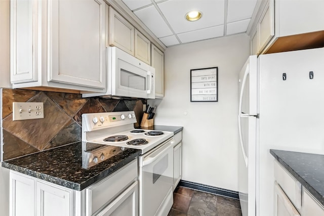 631 Village Rd Unit 34330, Breckenridge, CO 80424 - kitchen featuring white appliances, tasteful backsplash, a drop ceiling, dark stone counters, and dark stone finish floors