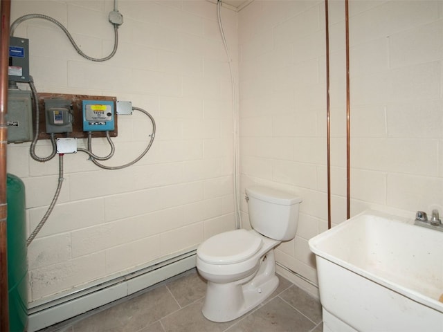 12715 E State Highway 82, Twin Lakes, CO 81251 - bathroom with baseboard heating, toilet, concrete block wall, vanity, and tile patterned floors