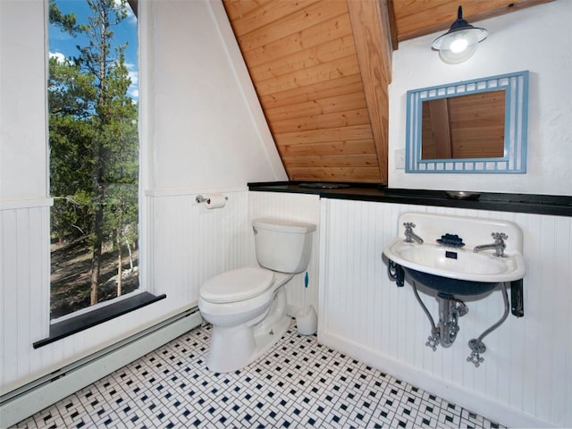 12715 E State Highway 82, Twin Lakes, CO 81251 - half bathroom featuring a baseboard radiator, toilet, a wainscoted wall, and tile patterned flooring