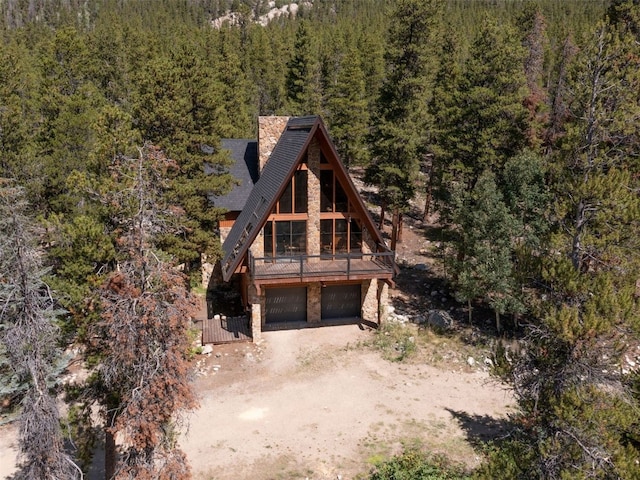 12715 E State Highway 82, Twin Lakes, CO 81251 - a-frame home with a forest view, stone siding, driveway, and a garage