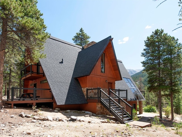 12715 E State Highway 82, Twin Lakes, CO 81251 - view of property exterior with a shingled roof, a deck, and stairway