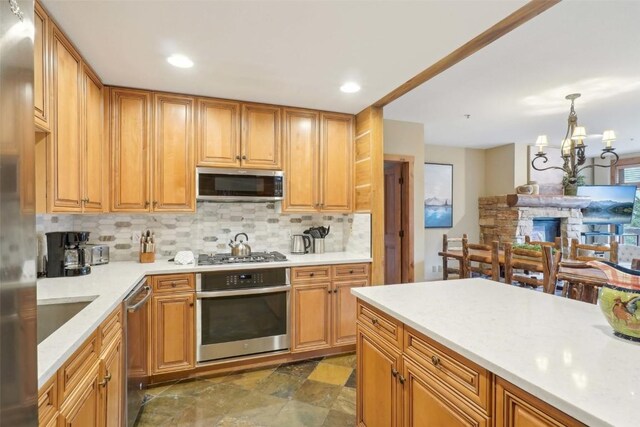 224 Trailhead Dr Unit 3075, Keystone, CO 80435 - kitchen featuring light countertops, appliances with stainless steel finishes, wood walls, and a sink