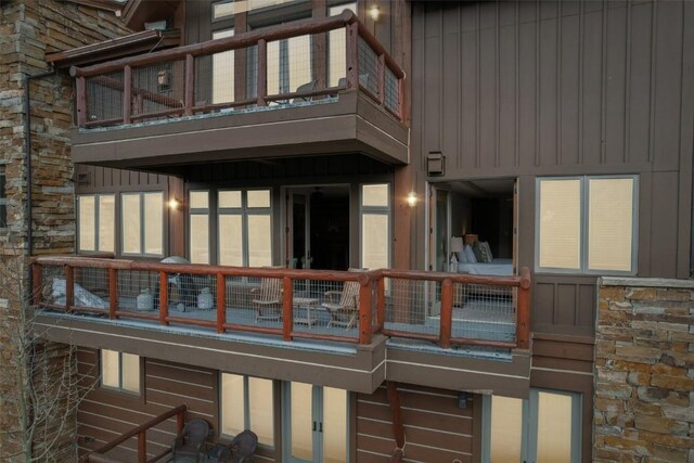 224 Trailhead Dr Unit 3075, Keystone, CO 80435 - back of house with board and batten siding, stone siding, and a balcony
