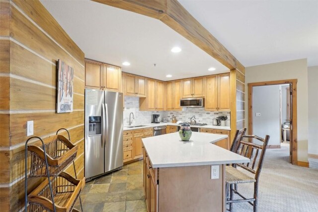 224 Trailhead Dr Unit 3075, Keystone, CO 80435 - kitchen featuring a sink, stone finish floor, stainless steel appliances, decorative backsplash, and a kitchen island