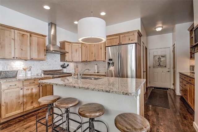 532 Kimmes Ln, Breckenridge, CO 80424 - kitchen featuring stainless steel appliances, wall chimney range hood, a sink, and light brown cabinets