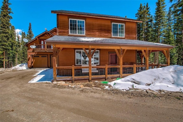 532 Kimmes Ln, Breckenridge, CO 80424 - rustic home with covered porch, driveway, roof with shingles, and an attached garage