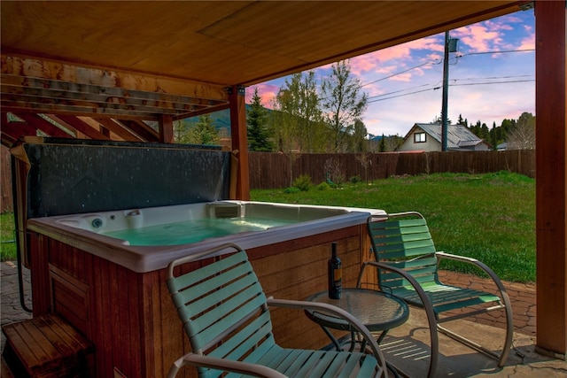 196 Vail Cir, Dillon, CO 80435 - deck at dusk featuring a hot tub and a fenced backyard