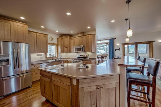 196 Vail Cir, Dillon, CO 80435 - kitchen with appliances with stainless steel finishes, recessed lighting, plenty of natural light, wood finished floors, and an island with sink