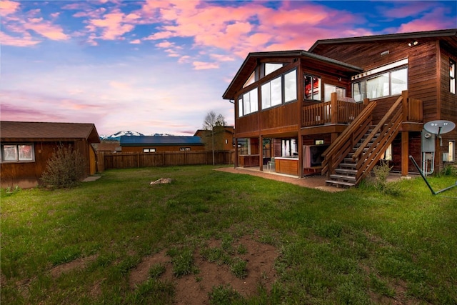 196 Vail Cir, Dillon, CO 80435 - back of house at dusk featuring a wooden deck, a patio, and stairway