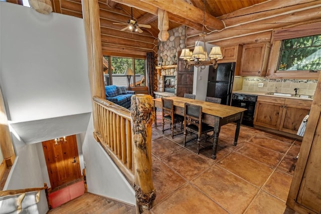 27800 Wapiti Way, Steamboat Springs, CO 80487 - dining space with log walls, wooden ceiling with exposed beams, a chandelier, a ceiling fan, and a stone fireplace