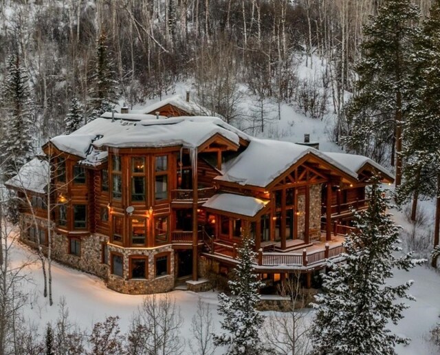 27800 Wapiti Way, Steamboat Springs, CO 80487 - snow covered property featuring stone siding, log exterior, and a chimney