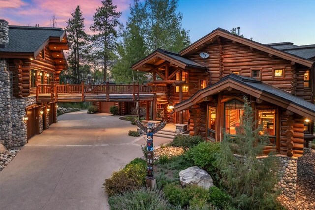 27800 Wapiti Way, Steamboat Springs, CO 80487 - log home with log siding, a deck, and concrete driveway