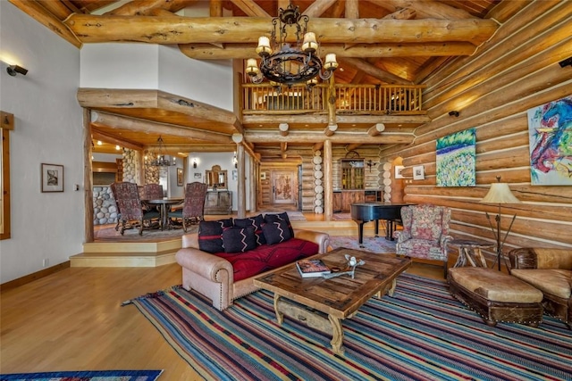 27800 Wapiti Way, Steamboat Springs, CO 80487 - living room with log walls, a chandelier, high vaulted ceiling, wood finished floors, and wood ceiling with exposed beams