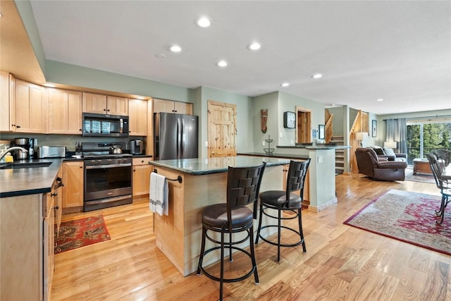 100 River Park Dr Unit 100A, Breckenridge, CO 80424 - kitchen featuring stainless steel appliances, dark countertops, light brown cabinets, light wood finished floors, and recessed lighting