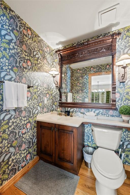 100 River Park Dr Unit 100A, Breckenridge, CO 80424 - bathroom featuring wallpapered walls, vanity, wood finished floors, and toilet