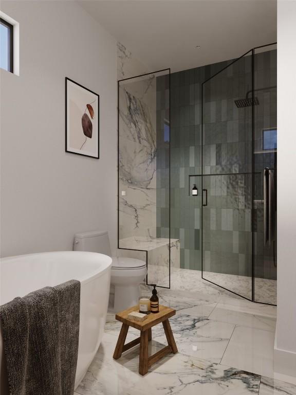bathroom with a shower stall, marble finish floor, toilet, and a soaking tub