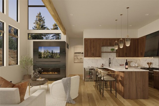 interior space with a glass covered fireplace, beverage cooler, and light wood-style floors