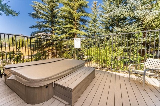 deck with a covered hot tub