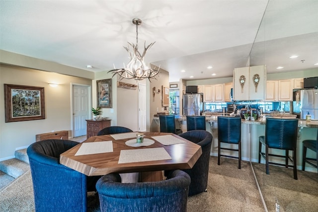 dining space with recessed lighting, light carpet, baseboards, and a notable chandelier