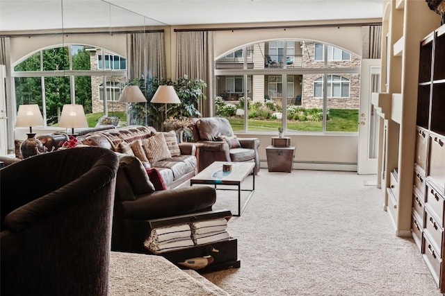 sunroom with a baseboard heating unit and plenty of natural light