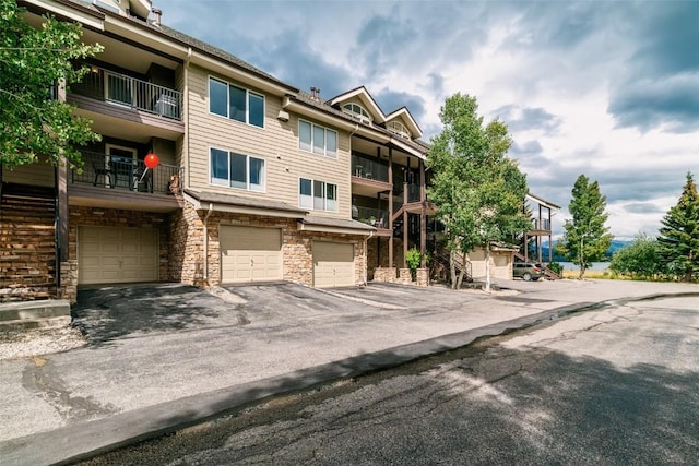 view of property with driveway and a garage