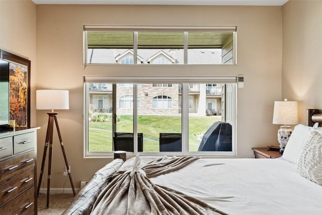 bedroom with baseboards and carpet