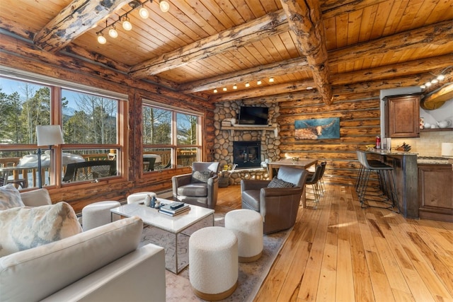 878 American Way, Breckenridge, CO 80424 - living room with light wood finished floors, beam ceiling, wood ceiling, a fireplace, and rail lighting