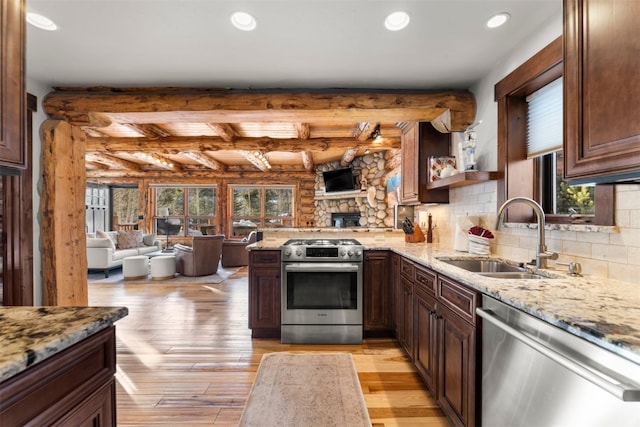 878 American Way, Breckenridge, CO 80424 - kitchen with open floor plan, appliances with stainless steel finishes, a sink, and light wood finished floors