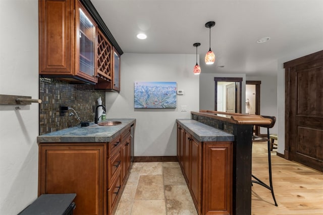 878 American Way, Breckenridge, CO 80424 - bar featuring pendant lighting, baseboards, a sink, and tasteful backsplash
