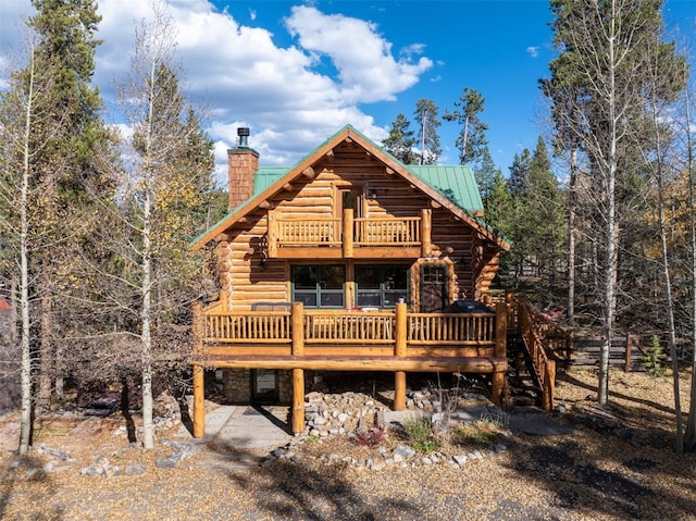 878 American Way, Breckenridge, CO 80424 - view of front of home featuring a chimney, a deck, log siding, and metal roof