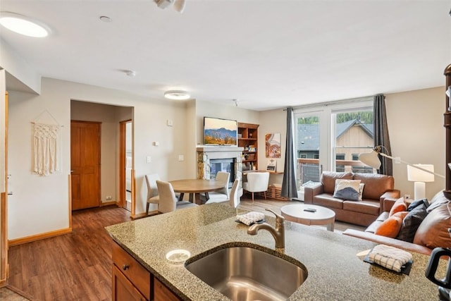129 River Run Rd Unit 8055, Keystone, CO 80435 - kitchen with a sink, open floor plan, wood finished floors, and a glass covered fireplace