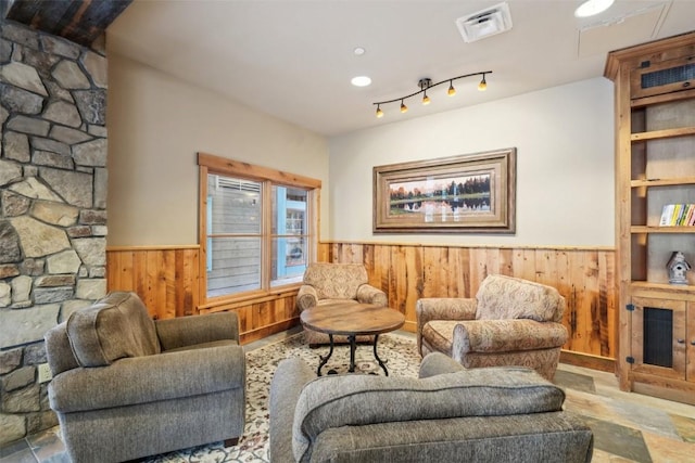 129 River Run Rd Unit 8055, Keystone, CO 80435 - living room featuring a wainscoted wall, wooden walls, and stone finish flooring