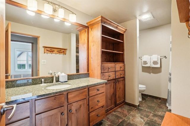 129 River Run Rd Unit 8055, Keystone, CO 80435 - bathroom with vanity, toilet, baseboards, and stone finish floors