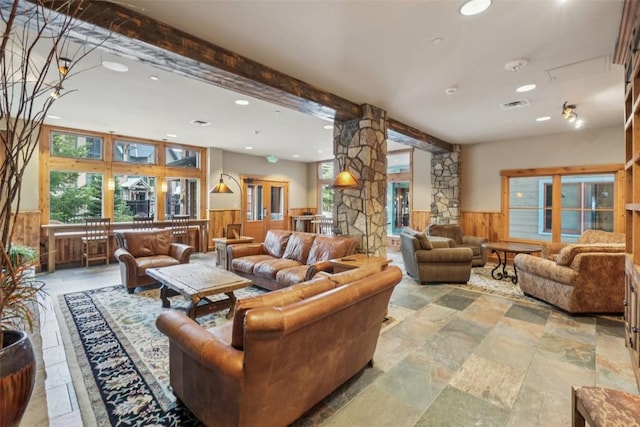 129 River Run Rd Unit 8055, Keystone, CO 80435 - living room featuring a wainscoted wall, recessed lighting, wood walls, stone tile flooring, and beamed ceiling