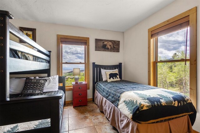 651 Lamb Mountain Rd, Fairplay, CO 80440 - bedroom with multiple windows and stone tile flooring