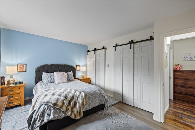133 Woodchuck Ct, Silverthorne, CO 80498 - bedroom with a barn door, wood finished floors, and baseboards