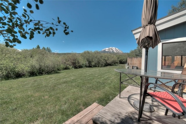 133 Woodchuck Ct, Silverthorne, CO 80498 - view of green lawn featuring a wooden deck and outdoor dining area