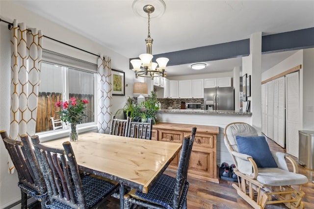 133 Woodchuck Ct, Silverthorne, CO 80498 - dining room featuring a chandelier and dark wood-style floors