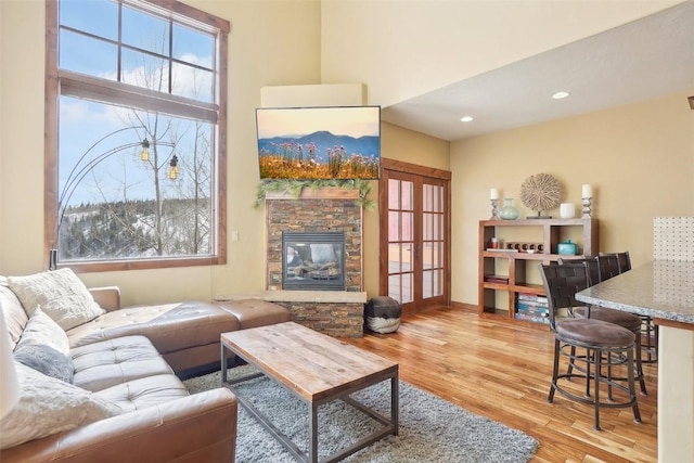 0050 County Road 1293 Unit B, Silverthorne, CO 80498 - living room featuring a healthy amount of sunlight, wood finished floors, and a fireplace